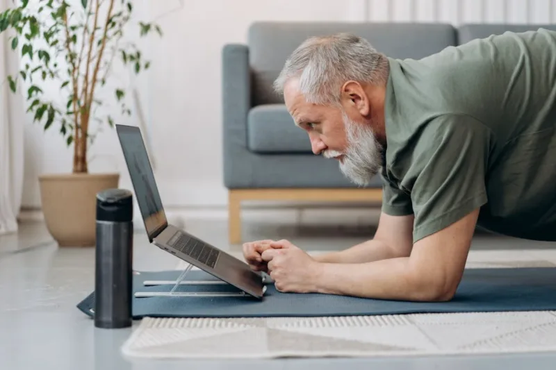 An elderly man taking training online