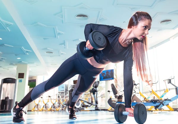 Woman Doing Exercise Inside Gym
