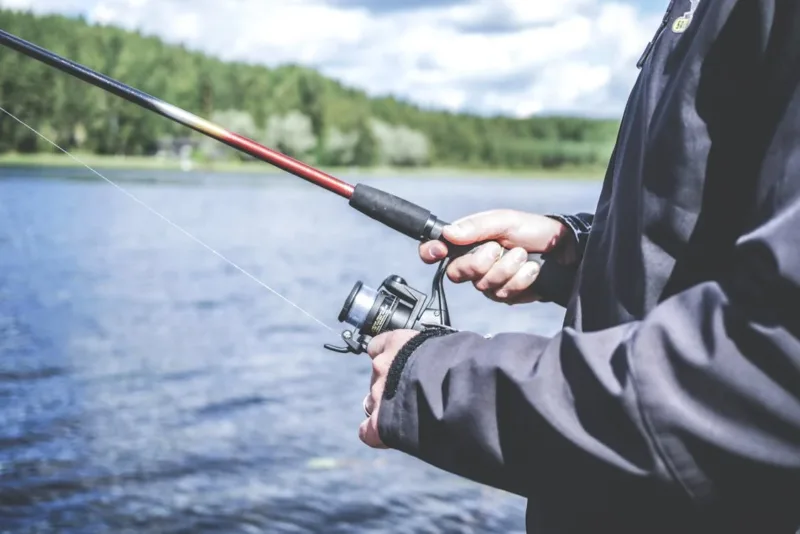 A person fishing by a lake