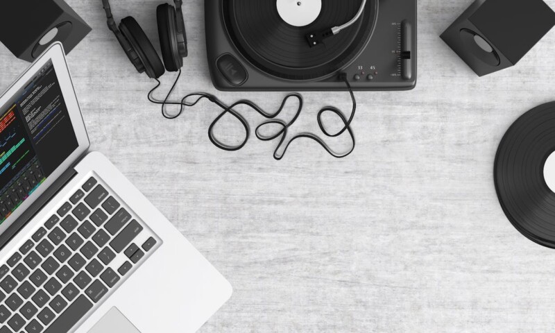 Macbook Pro Beside Black Headphones on Gray Table
