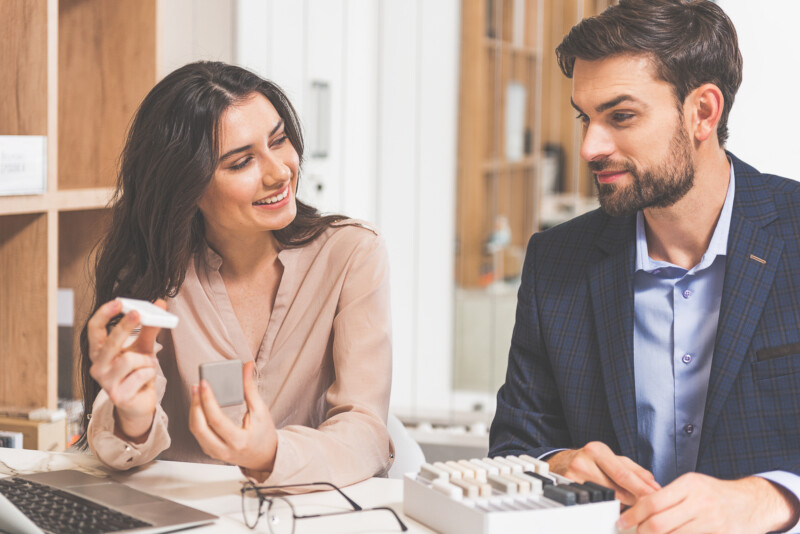 Young saleswoman proposing design product to buyer