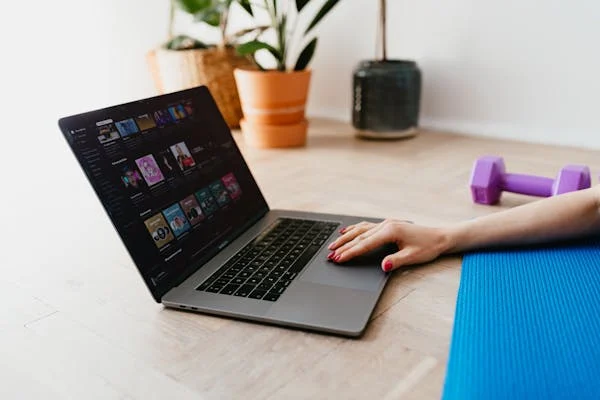 Faceless woman using laptop during sport exercising
